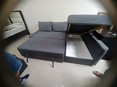 Grey fabric sofa bed with hidden storage - good condition