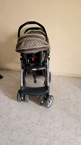 Well-used standard baby stroller with carseat and tray