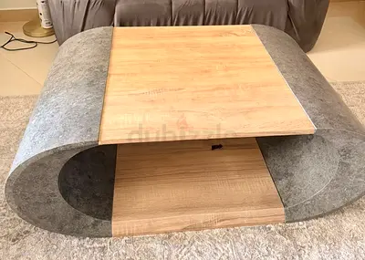 Modern curved coffee table with wood finish and stone-look sides