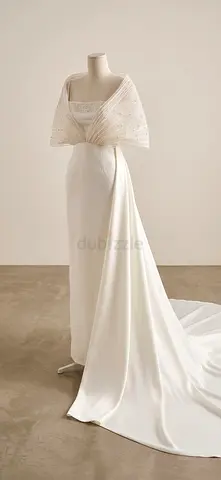 Elegant white dress with long train and embellished shawl