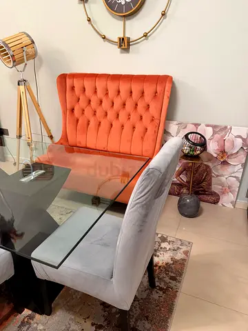 Glass Top Dining Table with Velvet Chairs - Set of 4 and orange Lounge chair.