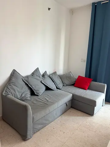 Grey L-shaped Corner Sofa bed with Cushions — Good Condition