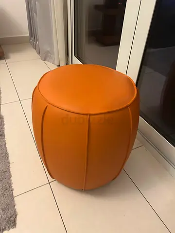 Round orange leather pouf/ottoman