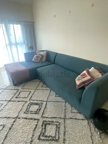 Modern teal L-shaped sofa with ottoman - good condition
