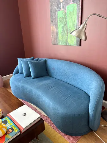 Blue curved 2-seater sofa with cushions - good condition