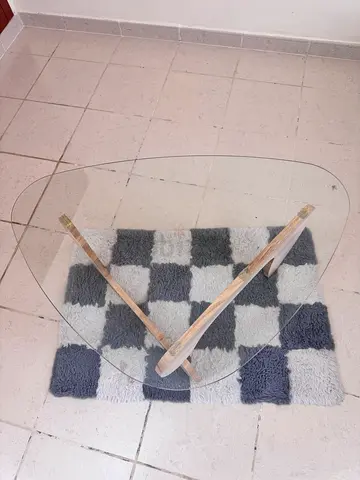 Modern Glass-top coffee table with wooden tripod base - modern design