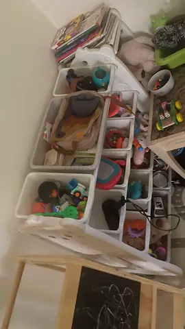 Kids toy organizer with assorted soft toys and activity pieces