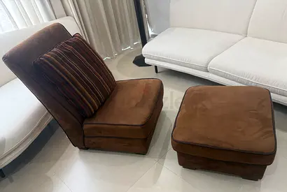 Brown suede lounge chair with matching ottoman