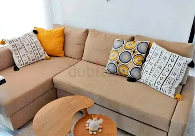 Beige L-shaped Corner Sofa with Storage and Cushions - Good Condition