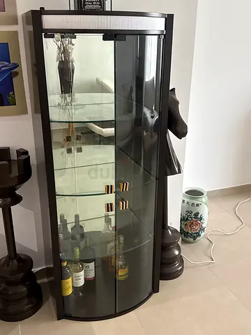 Dark wood curved glass display cabinet with shelves