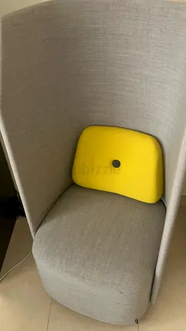 High-back privacy lounge chair with yellow lumbar cushion