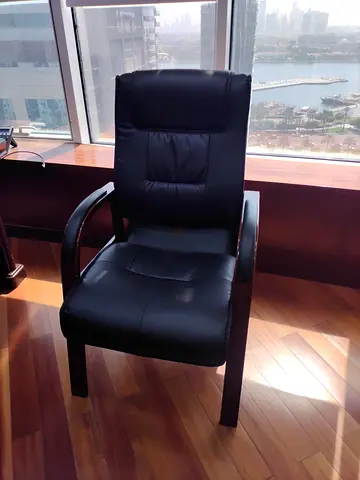 Black leather reclining lounge chair with wooden frame