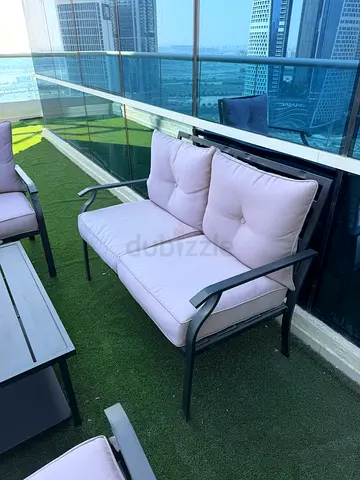 Outdoor patio lounge chair set with coffee table and cushions