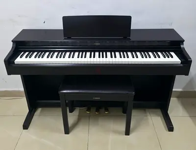The Yamaha Arius YDP-163R (Dark Rosewood) is an 88-key console digital piano featuring Graded Hammer