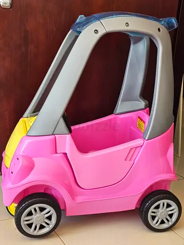 Pre-owned pink Cozy Coupe style ride-on car for toddlers