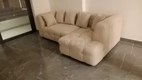 Beige L-shaped Tufted Sofa with Cushions - Good Condition