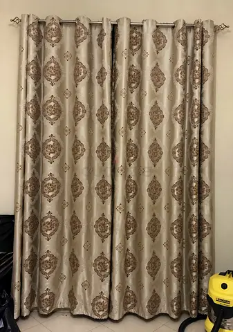 Pair of beige patterned curtains