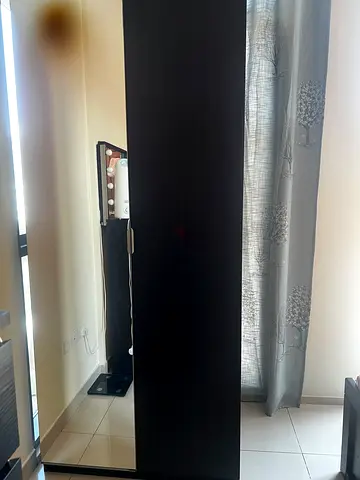 Tall black sliding door wardrobe with full-length mirror