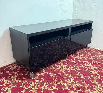 Black low TV cabinet with glossy drawers - modern media unit
