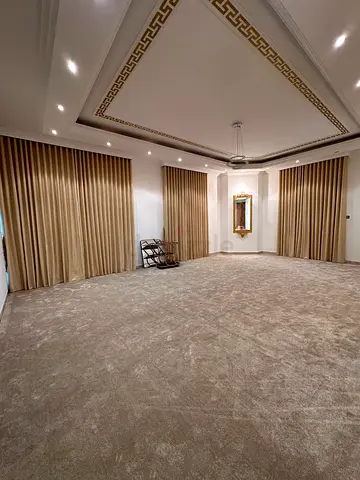 Large beige plush wall-to-wall carpet and blackout curtains in new condition