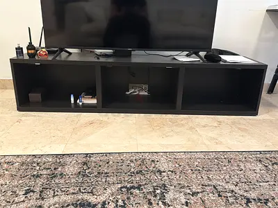 Low black TV entertainment unit with 3 open compartments