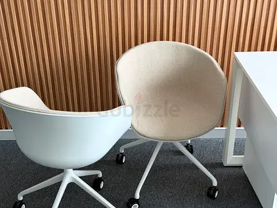 Pair of modern beige swivel office chairs on casters