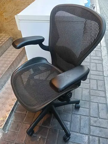 Herman Miller Ergonomic mesh office chair with adjustable armrests and lumbar support