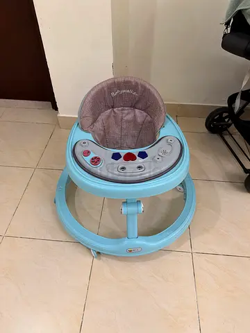 Light blue baby walker with music and activity tray - gently used