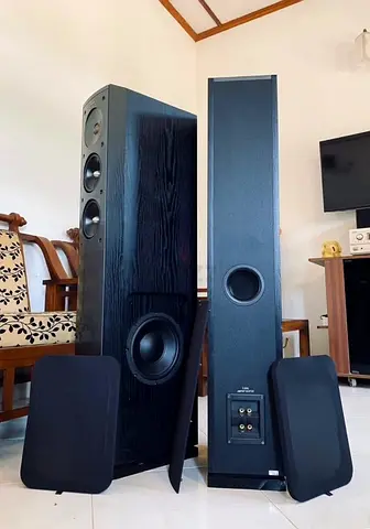 Pair of tall floorstanding stereo speakers with subwoofers