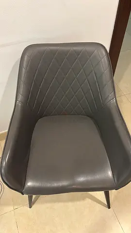 Grey leather dining chair with diamond-stitched back