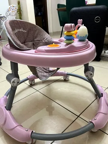 Lightly used pink baby walker with activity tray