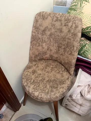 Used beige upholstered dining chair with wooden legs