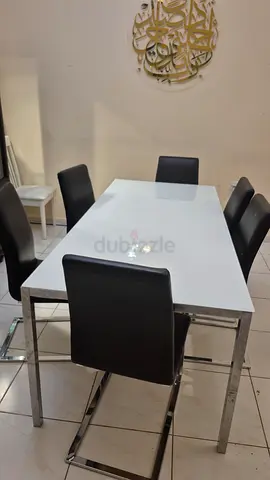 Modern white glass dining table with 6 black chairs - good condition