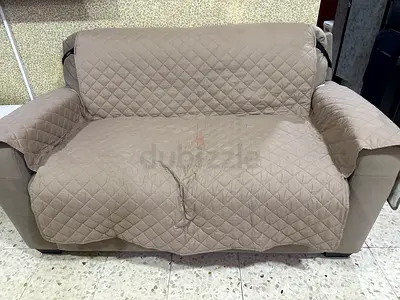 Two-seater sofa with washable quilted beige cover