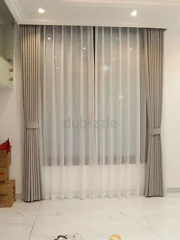 Light grey fabric curtains with sheer white inner panels