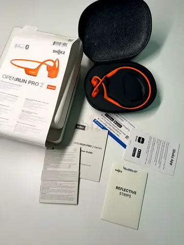 Shokz OpenRun Pro 2 premium open-ear bone conduction sport headphones in the vibrant Orange colorway