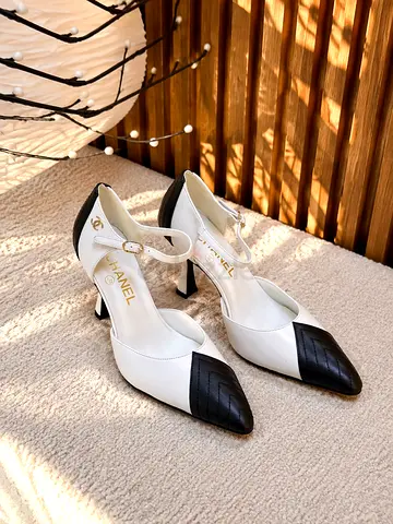 White and black two-tone Chanel ankle-strap heels, size unsure
