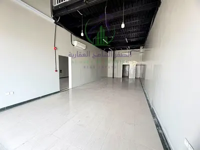Annual warehouse for rent in Industrial Area 12 with an area of 3,100 sq ft, one month free, 2 bathrooms, kitchen, mezzanine, and located on a main ro