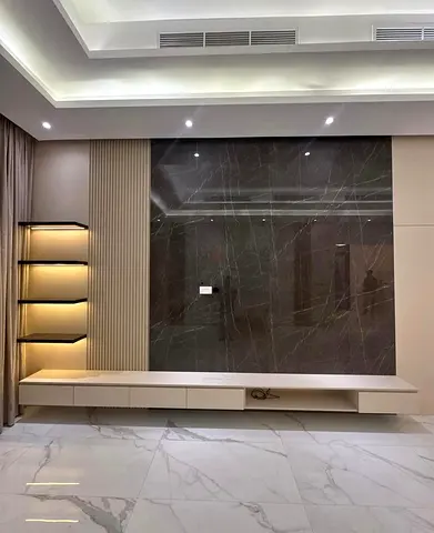 Modern wall-mounted entertainment unit with marble feature panel and LED shelves