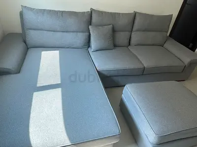 Light grey L-shaped fabric sofa with ottoman - good condition