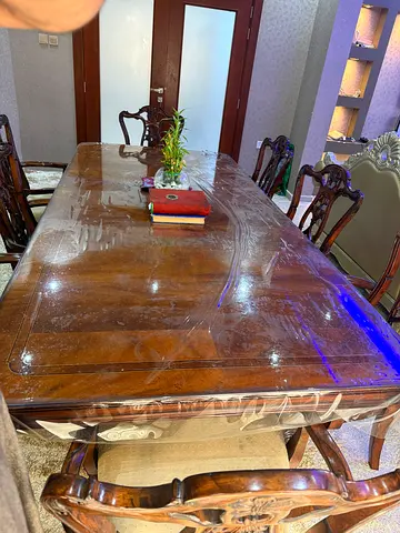 Solid wood dining table with 8 carved chairs - good condition
