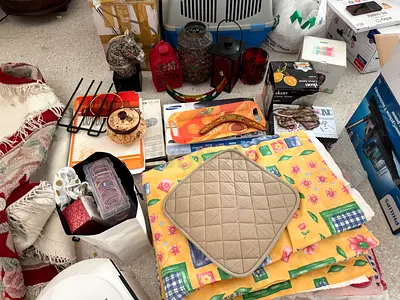 Varied items including wall decor items, lanterns, paintings, souvenirs, curtains, small appliances