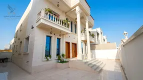 Partially furnished villa with central AC, covered parking, and a yard in Al-Aliya.