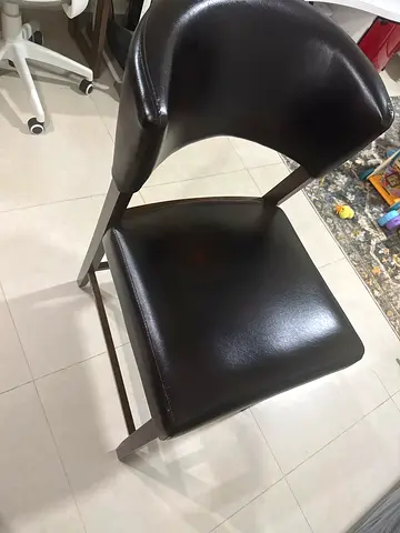 Dark brown dining table with leather dining chair in good condition