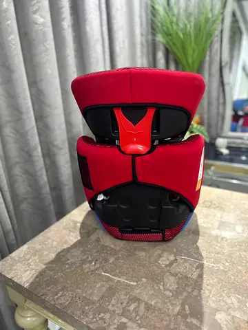 Red high-back booster car seat in good condition