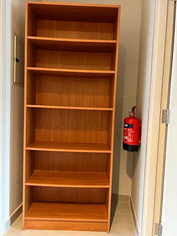 Tall wooden bookcase with multiple shelves - good condition