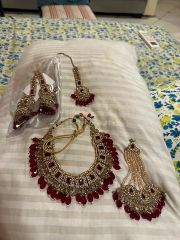 Indian bridal jewelry set - necklace, maang tikka, nath and earrings (red/gold)