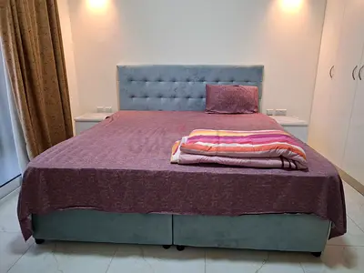 Queen size upholstered bed with mattress, two night stands, dresser