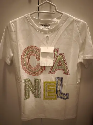 White Chanel rhinestone logo T‑shirt, multicolor crystal letters, size tag appears