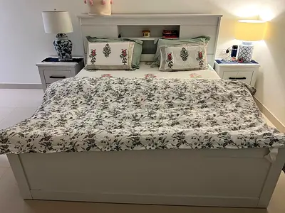 White wooden double bed frame with headboard storage